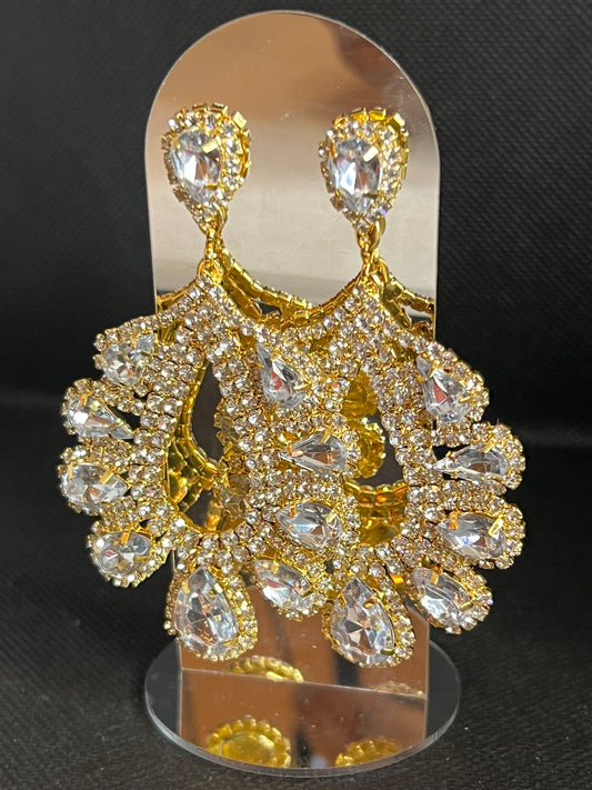 Gold and crystal brooch on a black background